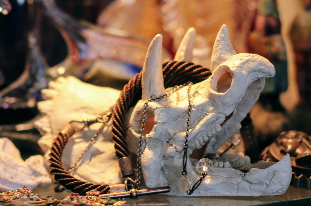 Pictured here is a miniature replica of a dinosaur skull and draped over it is a watch chain made entirely of human hair.